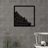 Meow metal wall art in Texture Black hanging above a sofa in a living room, 49x49cm