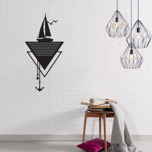 Anchor metal wall art in Texture Black hung above a sofa in a living room, 32x64cm