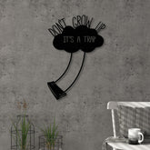 Don't Grow Up metal wall art in Texture Black, 35x51cm, displayed on a bedroom wall