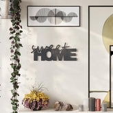 Sweet Home metal decorative wall art in Texture Black hanging in a hallway, 35x14cm