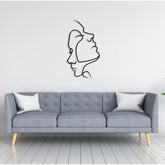 Two Face Metal Wall Art (75x42cm) in Texture Black, hung above a sofa