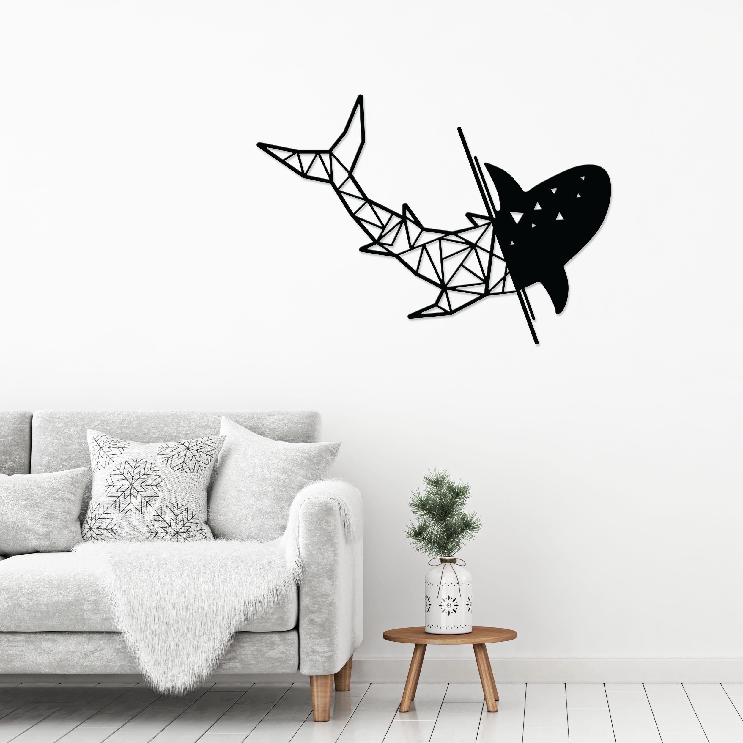 Shark metal wall art in Texture Black hung above a sofa in a living room, 64x45cm