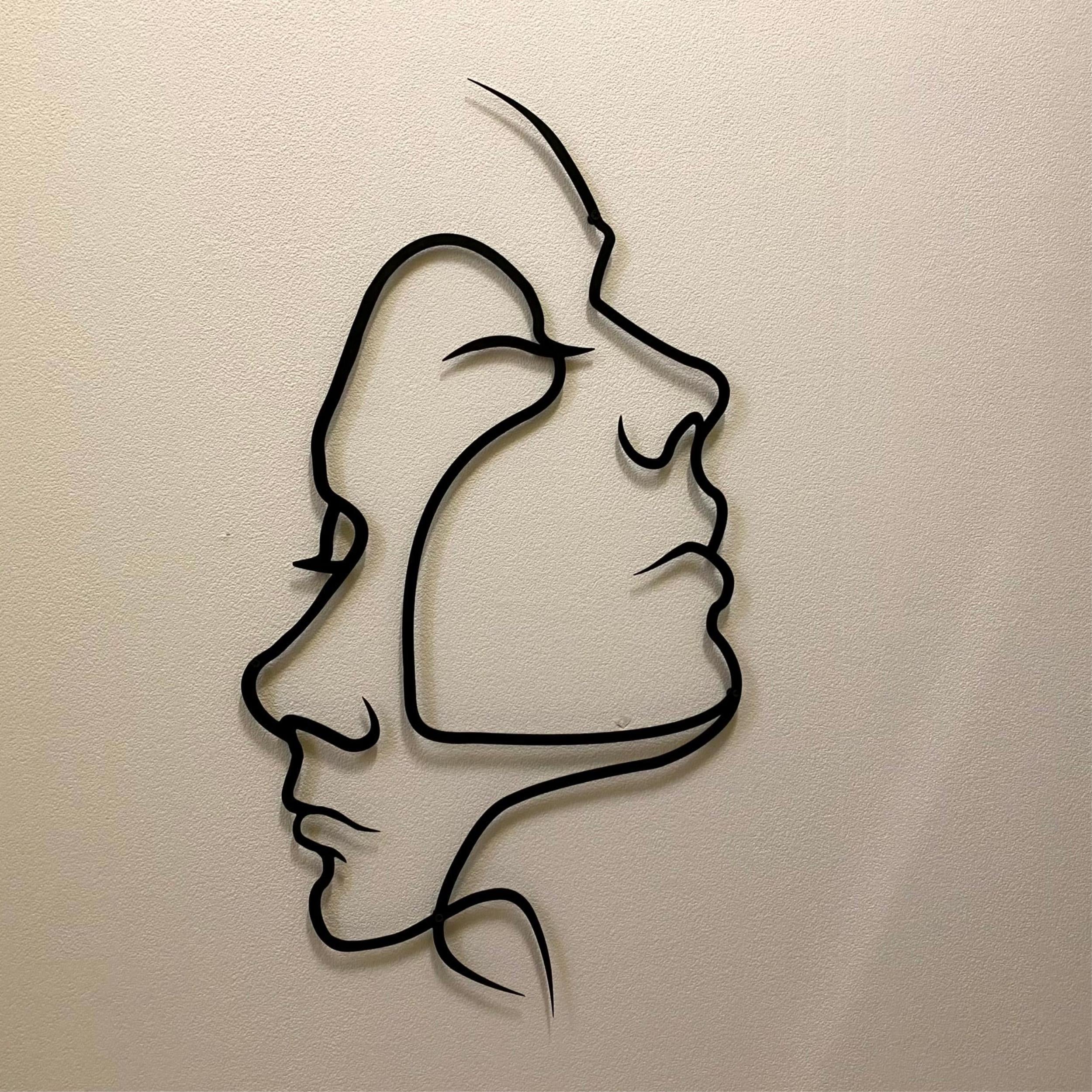 Two Face Metal Wall Art (75x42cm) displayed on a wall
